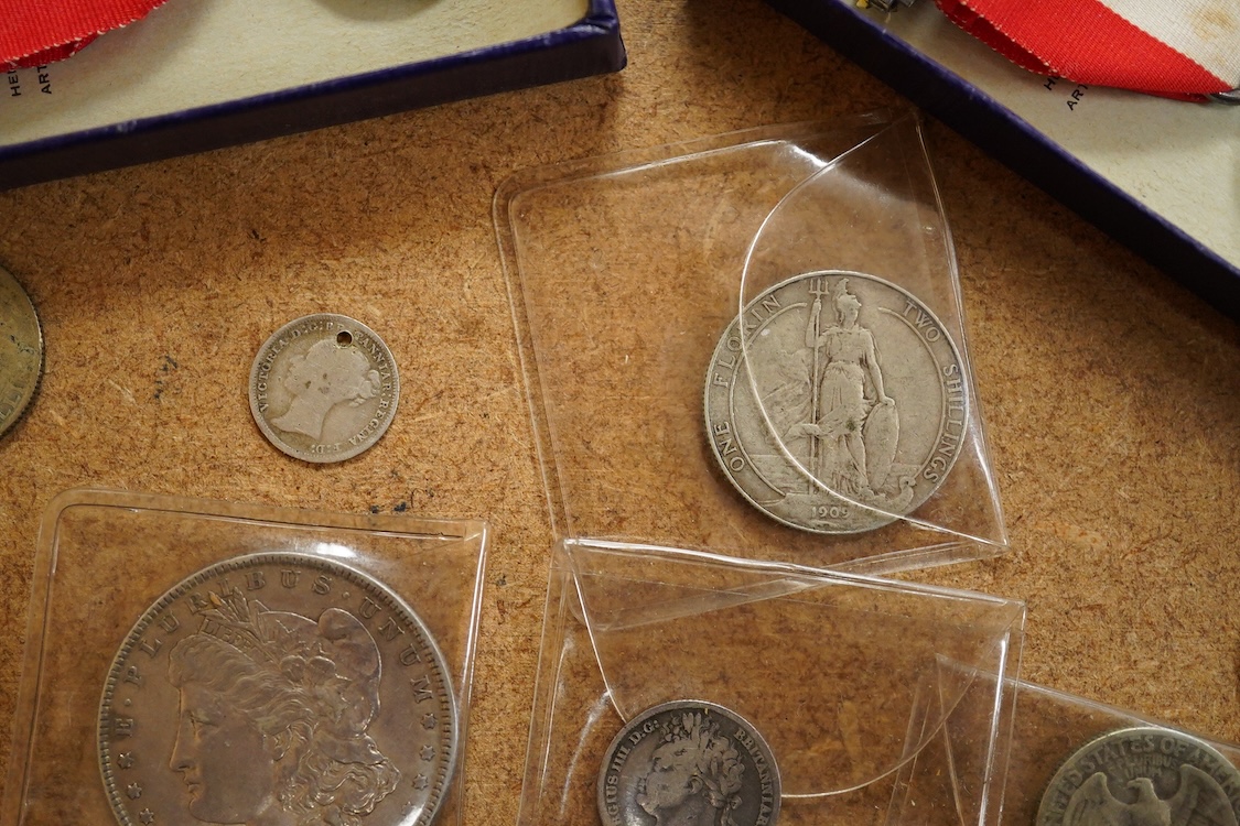 A small collection of silver coins and medals to include George III crown, 1820, Usa Morgan dollar, 1885, Edward VII florin, 1909, two George VI coronation medals in original boxes etc